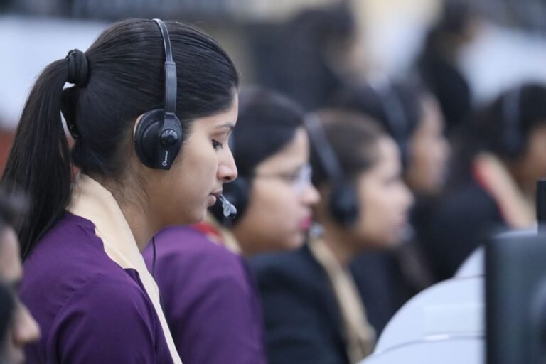 Customer support executives with headsets in a BPO office