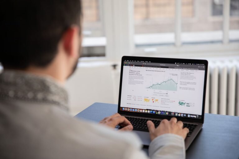 Professional reviewing marketing analytics on a laptop